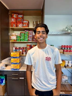 A youth volunteer manning a shop.