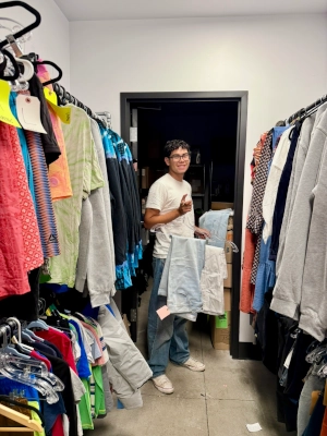 A volunteer checking and sorting clothes for distribution.